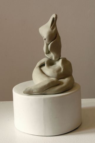 Figure Seated on Cylinder