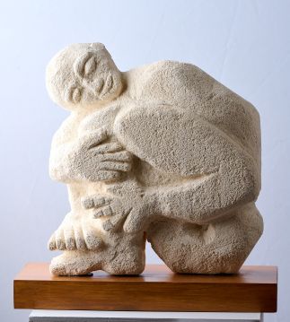 Man hugging his legs